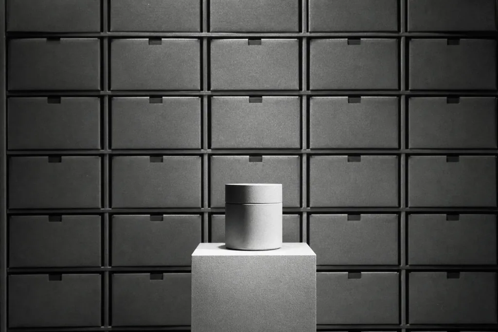 A wall of boxed goods with one product isolated on a pedestal