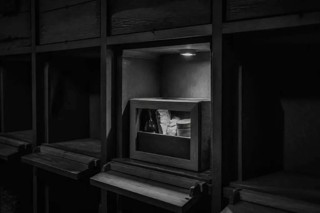 A small crate seated in a recessed wooden stockroom bay